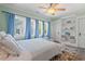 Well-lit bedroom featuring a ceiling fan, built-in shelves, and multiple windows at 2416 W Club Blvd, Durham, NC 27705
