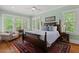 Bedroom with four-poster bed, ceiling fan, and hardwood floors at 2416 W Club Blvd, Durham, NC 27705