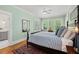 Bedroom featuring large windows, beautiful hardwood floors, and an attached bathroom at 2416 W Club Blvd, Durham, NC 27705