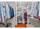 Walk-in closet with rods, shelving, hardwood floors, and a bench seat at 2416 W Club Blvd, Durham, NC 27705