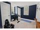 Well-lit exercise room with navy blue walls, an exercise bike, and weightlifting equipment at 2416 W Club Blvd, Durham, NC 27705