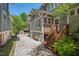 Charming home exterior with a wooden staircase leading to the entrance, and a shed in the yard at 2416 W Club Blvd, Durham, NC 27705