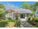 Charming home with a stone pathway, a welcoming front porch, and mature landscaping with a blooming tree at 2416 W Club Blvd, Durham, NC 27705