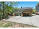 Back of home with a deck, patio, and driveway offers outdoor entertaining possibilities at 2416 W Club Blvd, Durham, NC 27705