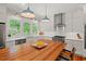 Kitchen featuring a wooden island with seating, stainless steel appliances, and a view of the backyard at 2416 W Club Blvd, Durham, NC 27705