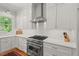 Modern kitchen features stainless steel appliances, white cabinets, and bright natural light at 2416 W Club Blvd, Durham, NC 27705