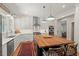 Well-lit kitchen with white cabinets, stainless steel appliances, and large wooden island with bar stool seating at 2416 W Club Blvd, Durham, NC 27705