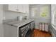 Laundry room with modern washer and dryer, granite countertops, and ample storage cabinets at 2416 W Club Blvd, Durham, NC 27705