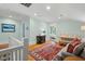 Attic living area with hardwood floors, a comfortable sofa, work desk, and bright rug at 2416 W Club Blvd, Durham, NC 27705