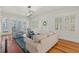 Bright living room with hardwood floors, modern lighting, and comfortable seating arrangement at 2416 W Club Blvd, Durham, NC 27705