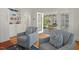 Cozy living room featuring hardwood floors, built-in shelves, and comfortable armchairs with patterned pillows at 2416 W Club Blvd, Durham, NC 27705