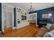 Spacious living room featuring hardwood floors, built-in shelving, and a comfortable sofa with stylish accents at 2416 W Club Blvd, Durham, NC 27705