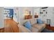 Open living room features hardwood floors, built-in shelving, and a comfortable seating area with blue accents at 2416 W Club Blvd, Durham, NC 27705