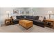 Basement living room features an oversized couch, lamps, and side tables at 2416 W Club Blvd, Durham, NC 27705