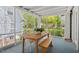 Inviting screened porch featuring a table and bench, providing a relaxing outdoor dining space at 2416 W Club Blvd, Durham, NC 27705