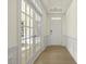 Bright hallway featuring white trim, wood floors, and a view through glass doors at 25 Long Needle Ct # 37, Youngsville, NC 27596