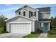 Charming two-story home with a two-car garage, manicured lawn and a welcoming blue front door at 2640 Pivot Ridge Dr, Raleigh, NC 27616