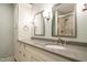 Bathroom featuring granite countertop, double mirrors, vanity lighting, and neutral tones at 2916 Rue Sans Famille, Raleigh, NC 27607