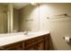 Bathroom featuring a long countertop, wood cabinets, and shower over tub at 2916 Rue Sans Famille, Raleigh, NC 27607