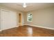 Bright bedroom features hardwood floors, closet, ceiling fan, and window with natural light at 2916 Rue Sans Famille, Raleigh, NC 27607