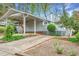 Charming home with a covered driveway and landscaped front yard and gray wood siding at 2916 Rue Sans Famille, Raleigh, NC 27607