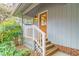 Charming front entrance featuring a wooden door, gray siding, and inviting landscaping at 2916 Rue Sans Famille, Raleigh, NC 27607