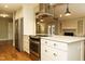 Modern kitchen with a stainless-steel range hood and white custom cabinetry at 2916 Rue Sans Famille, Raleigh, NC 27607