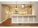 Bright kitchen with stainless hood vent, bar seating, hardwood floors, and recessed lighting at 2916 Rue Sans Famille, Raleigh, NC 27607