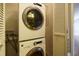 Stacked washer and dryer with white units, and a white louvered door nearby at 2916 Rue Sans Famille, Raleigh, NC 27607