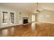 Bright living room showcasing a stone fireplace, built-in shelves and French doors at 2916 Rue Sans Famille, Raleigh, NC 27607