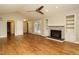 Spacious living room featuring a fireplace with built-in shelving and wood flooring at 2916 Rue Sans Famille, Raleigh, NC 27607