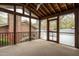 A wide-open screened porch with vaulted ceiling, ceiling fan, and a wooden railing at 2916 Rue Sans Famille, Raleigh, NC 27607