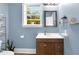 Bathroom featuring a window, a dark wood vanity, and decorative shelving at 303 E J St, Erwin, NC 28339