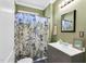 Well-lit bathroom with a vanity, mirror, and a stylish shower curtain adding a touch of elegance at 303 E J St, Erwin, NC 28339