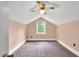 Bedroom with a window, neutral carpet, and sloping walls at 303 E J St, Erwin, NC 28339