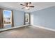 Spacious bedroom with natural light, ceiling fan, and neutral carpet at 303 E J St, Erwin, NC 28339