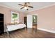 Bright bedroom with neutral walls, hardwood floors, and a large window providing ample natural light at 303 E J St, Erwin, NC 28339