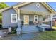 Inviting front porch with a swing, seating, decorative plants, and charming details enhancing the curb appeal at 303 E J St, Erwin, NC 28339