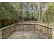 Backyard view from a wood deck, with trees and storage shed in the distance at 312 Greenwood Dr, Durham, NC 27704