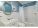 Bathroom with a toilet, vanity, mirror, and bathtub with shower, tiled to ceiling at 312 Greenwood Dr, Durham, NC 27704