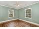 Bedroom featuring hardwood floors and two windows offering ample natural light at 312 Greenwood Dr, Durham, NC 27704