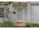 Inviting front porch featuring decorative columns and a mailbox, with detailed trim at 312 Greenwood Dr, Durham, NC 27704