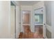 Hallway with wooden floors connects to rooms; natural light streams through open doorways at 312 Greenwood Dr, Durham, NC 27704