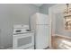 Functional kitchen with white appliances, with an adjacent dining area at 312 Greenwood Dr, Durham, NC 27704