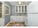 Efficient kitchen with white cabinets, a window over the sink, and linoleum floors at 312 Greenwood Dr, Durham, NC 27704