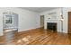 Bright living room with hardwood floors, a decorative fireplace, and an adjacent sitting room at 312 Greenwood Dr, Durham, NC 27704