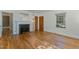 Cozy living room with hardwood floors, a fireplace, and a closet, filled with natural light at 312 Greenwood Dr, Durham, NC 27704