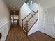 Bright foyer features wood floors, a staircase with white railings and paneled walls at 316 Catheys Creek Cir, Wendell, NC 27591