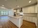 Stylish kitchen with granite island, stainless hood, open layout and wood flooring at 316 Catheys Creek Cir, Wendell, NC 27591