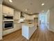Modern kitchen with white cabinets, stainless steel appliances, and a granite-topped island at 316 Catheys Creek Cir, Wendell, NC 27591